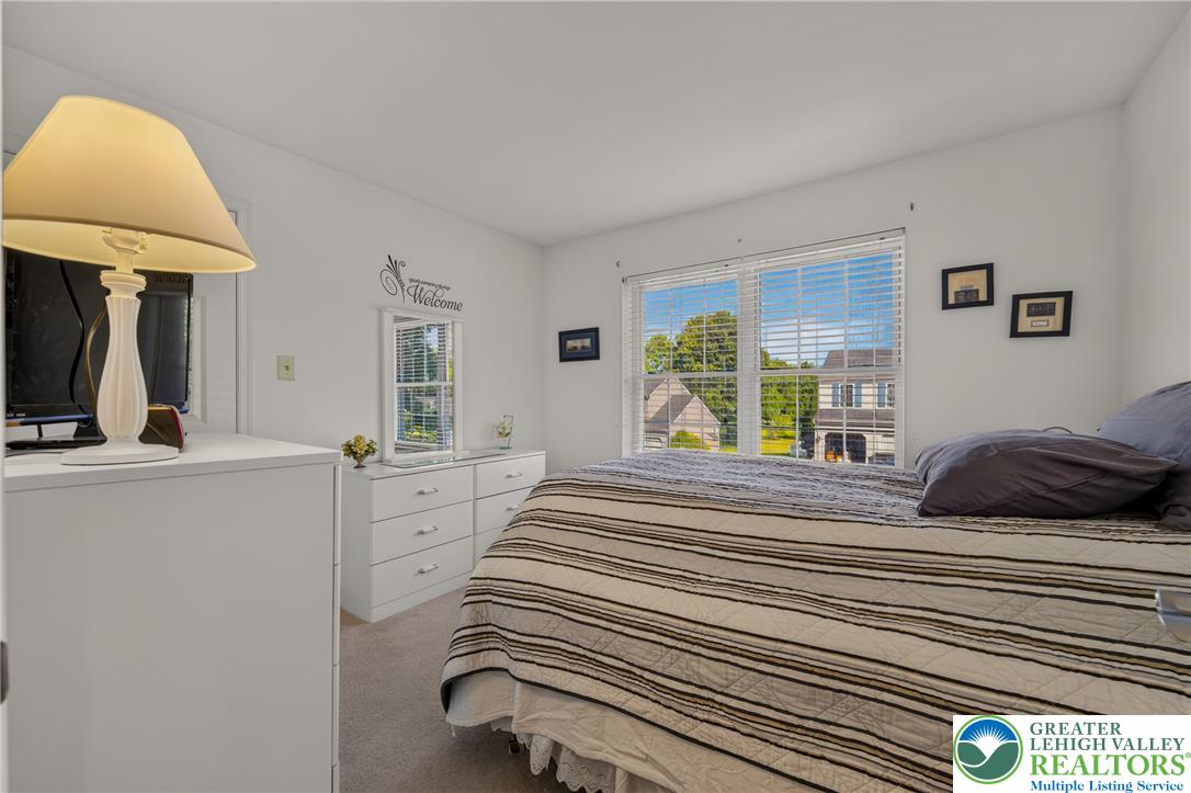 1702 Red Bud Road Quakertown, PA 18951 - Photo 43 of 68 A cozy bedroom with soft carpet flooring and multiple windows offers a comfortable living space.