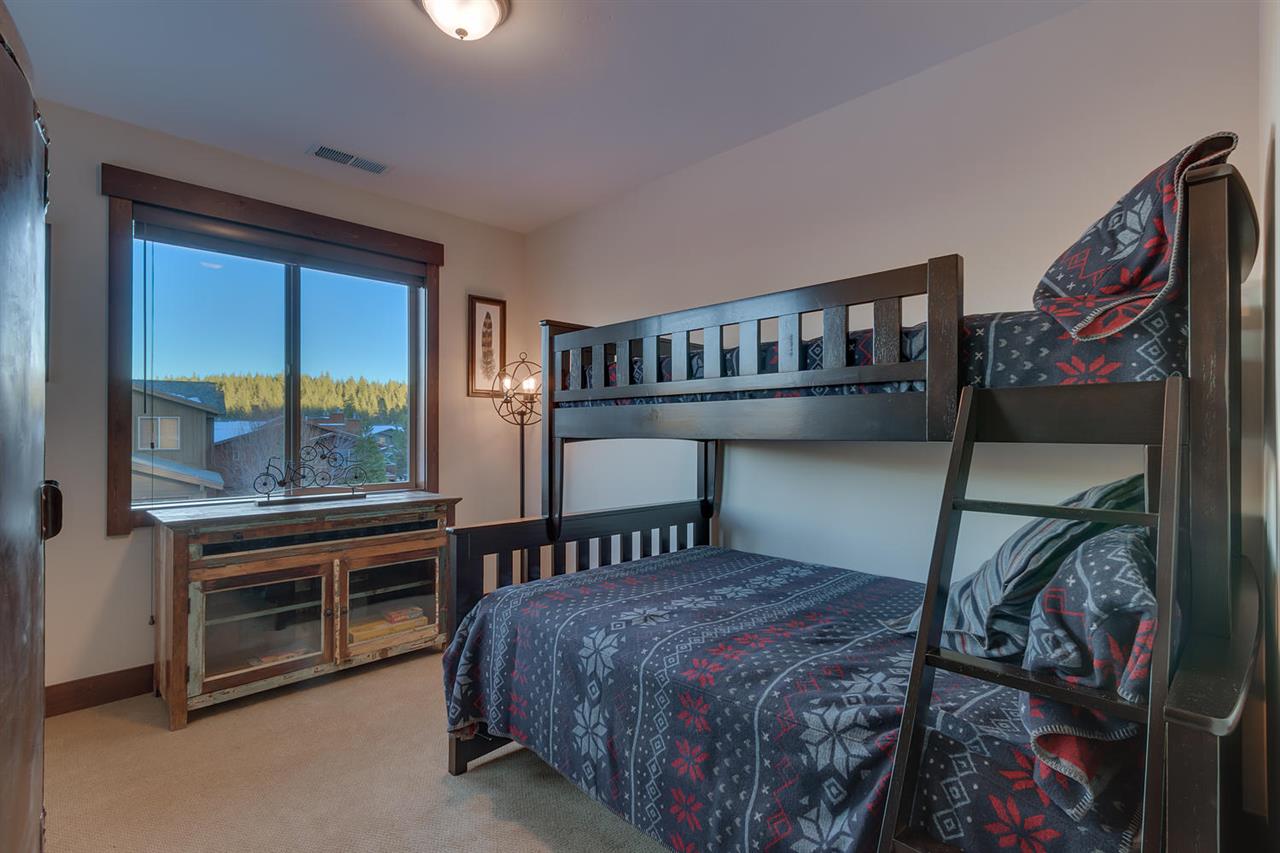 11679 McClintock Loop, Unit 1 Truckee, CA 96161 - Photo 11 of 19 a bedroom with a bed next to a large window