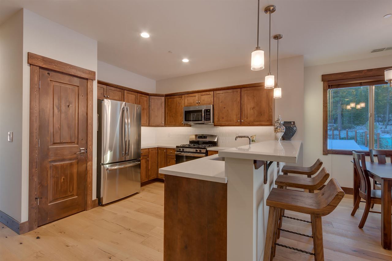 11679 McClintock Loop, Unit 1 Truckee, CA 96161 - Photo 3 of 19 a kitchen with refrigerator and chairs