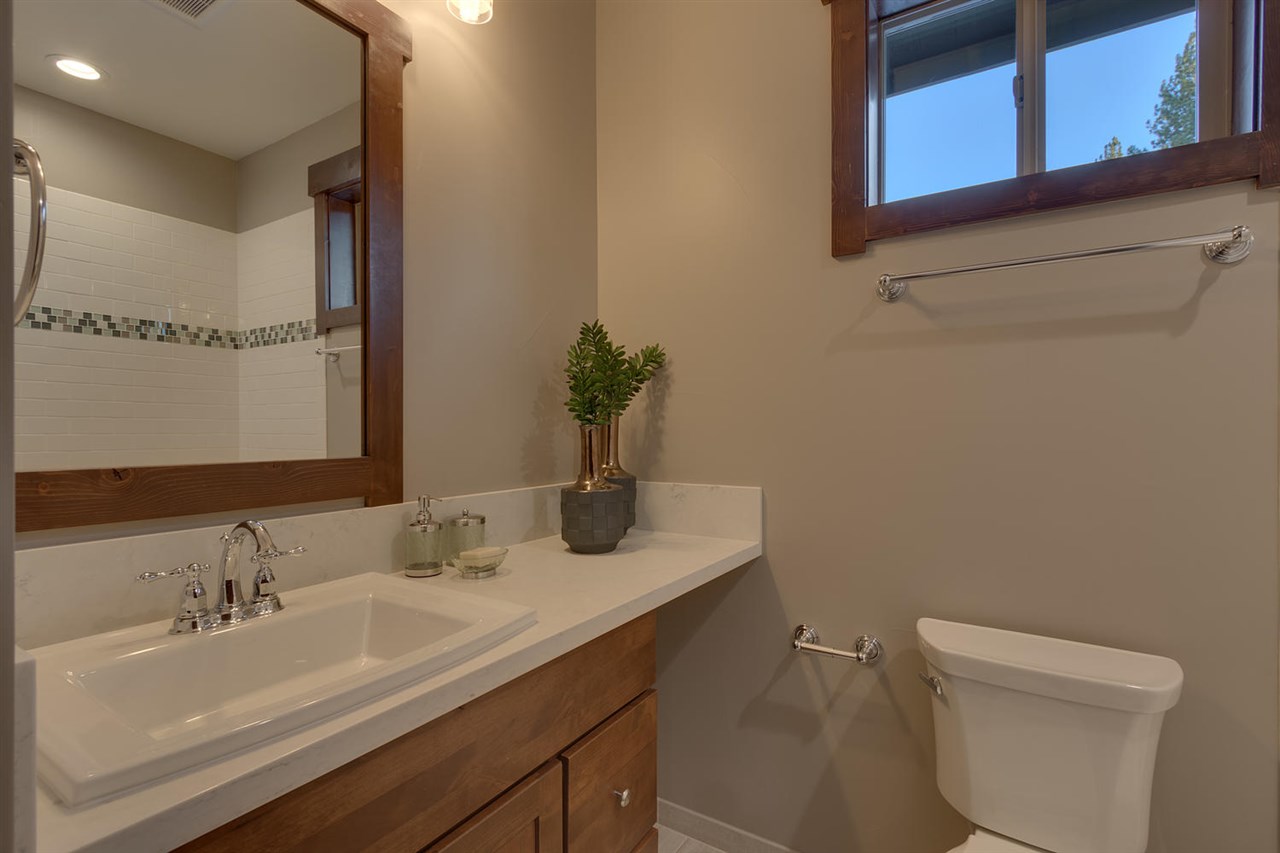 11679 McClintock Loop, Unit 1 Truckee, CA 96161 - Photo 10 of 19 a bathroom with a granite countertop sink toilet and a mirror