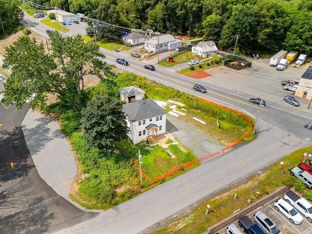 an aerial view of a house with a yard lake and mountain view