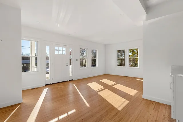 a living room with furniture flat screen tv and a large window