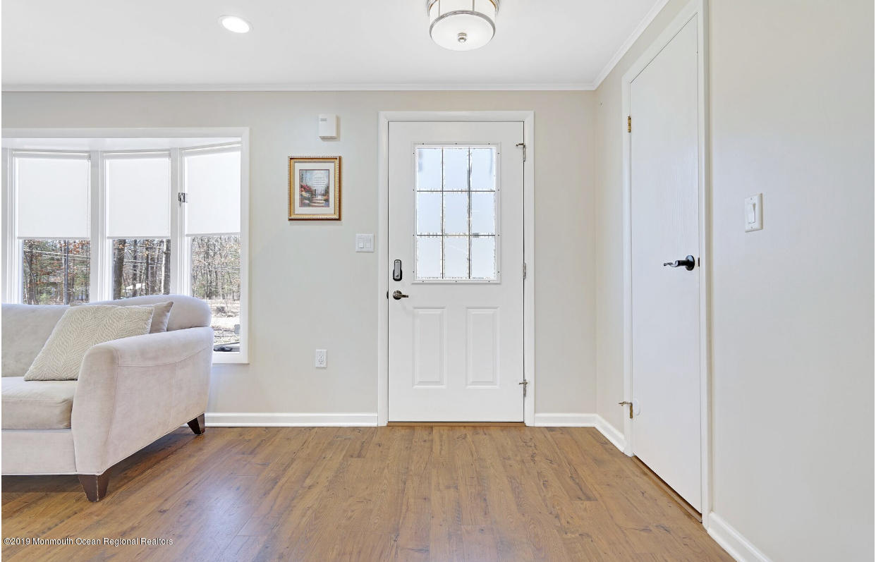 219 Jackson Pines Road Jackson, NJ 08527 - Photo 12 of 26 a view of an empty room with wooden floor and a window