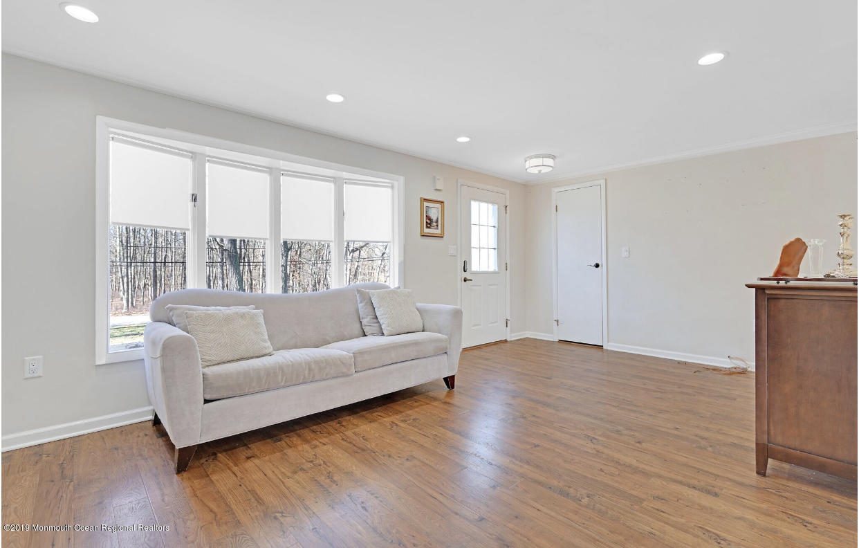 219 Jackson Pines Road Jackson, NJ 08527 - Photo 13 of 26 a living room with furniture and a large window