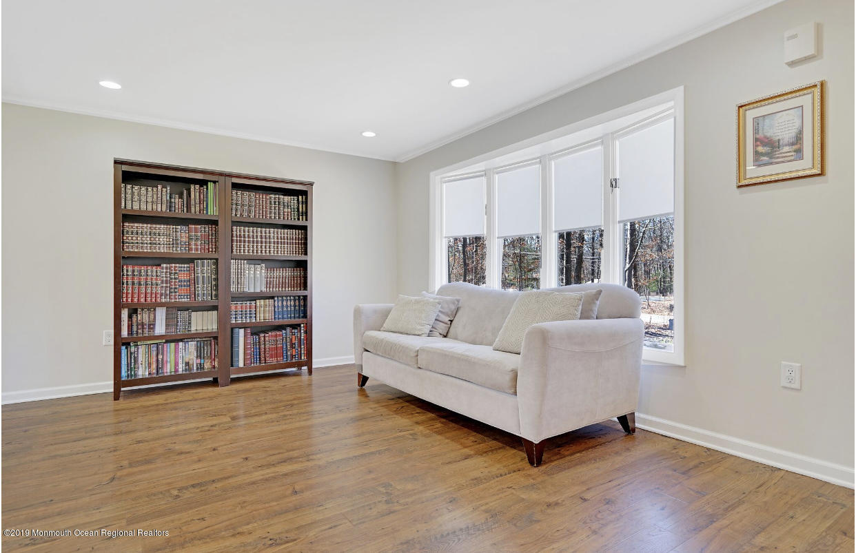 219 Jackson Pines Road Jackson, NJ 08527 - Photo 14 of 26 a living room with furniture and a book shelf