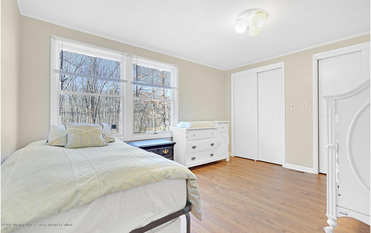 219 Jackson Pines Road Jackson, NJ 08527 - Photo 17 of 26 a bedroom with a bed and a window