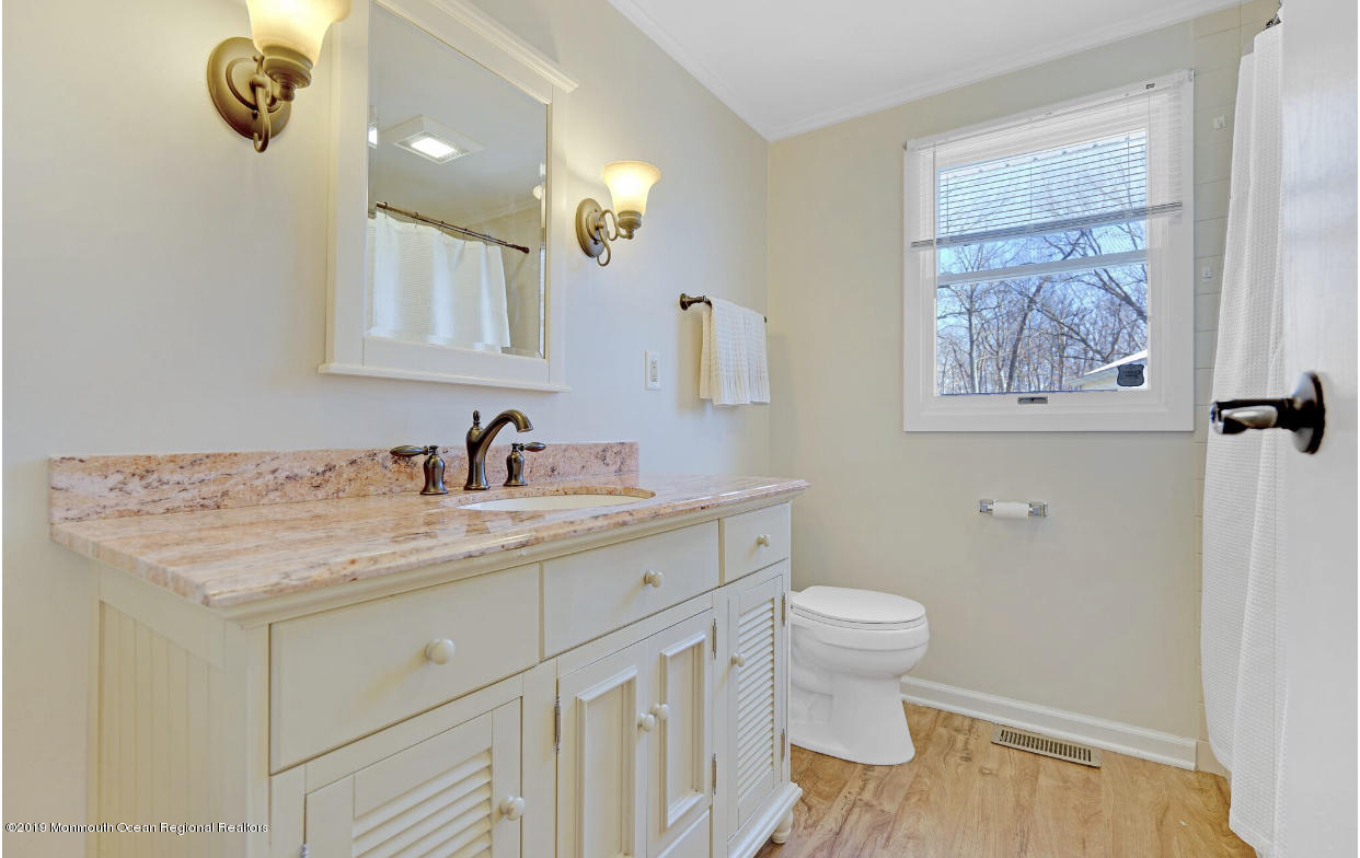 219 Jackson Pines Road Jackson, NJ 08527 - Photo 18 of 26 a bathroom with a sink a toilet and a mirror