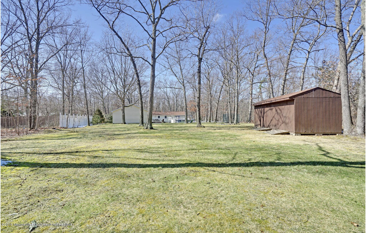 219 Jackson Pines Road Jackson, NJ 08527 - Photo 24 of 26 a swimming pool with outdoor seating and yard