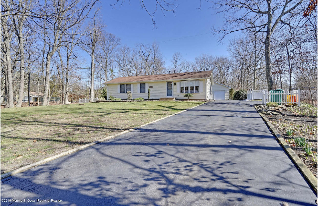 219 Jackson Pines Road Jackson, NJ 08527 - Photo 3 of 26 a front view of a house with a yard and trees