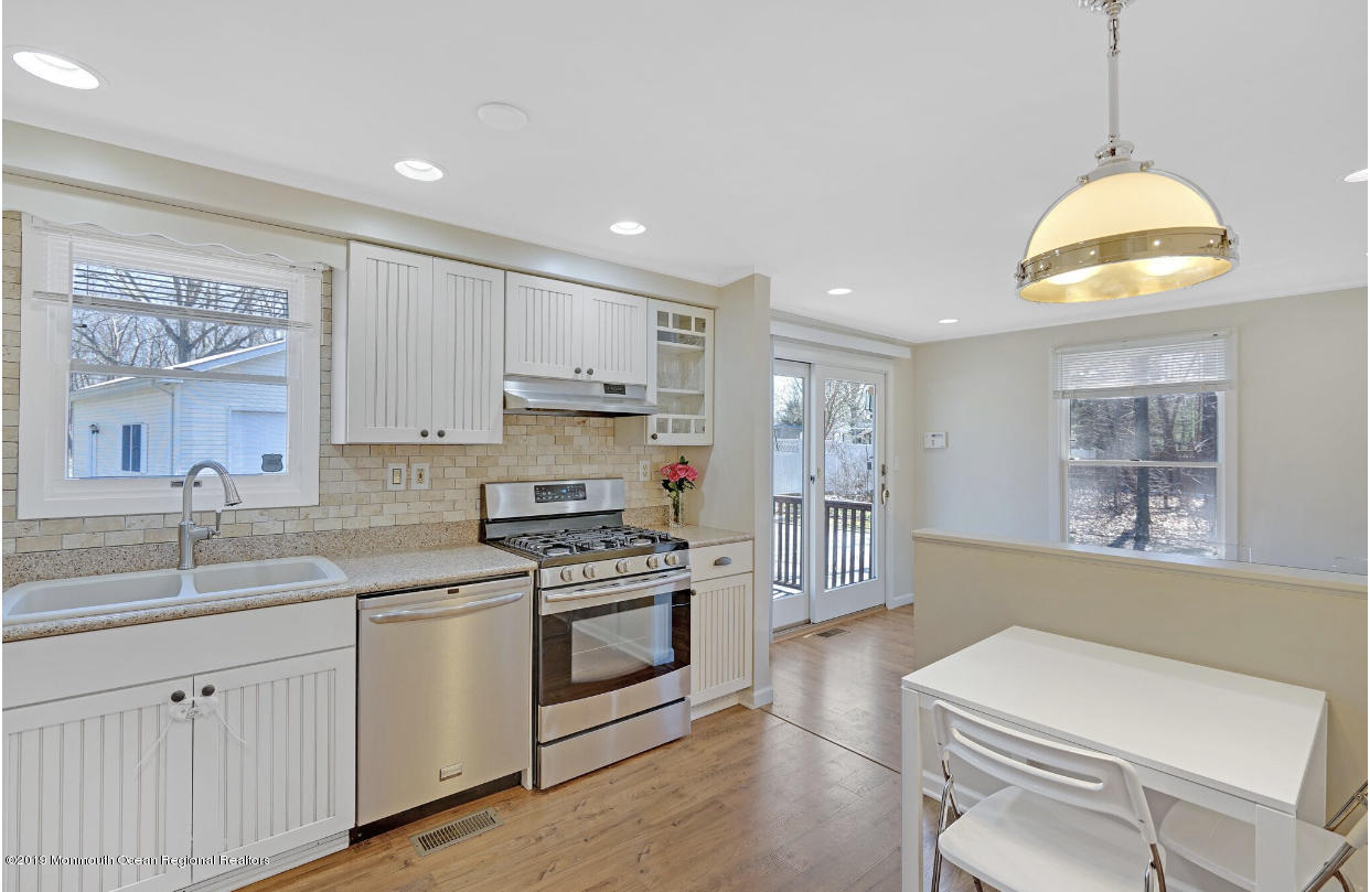 219 Jackson Pines Road Jackson, NJ 08527 - Photo 6 of 26 a kitchen with a sink stove and wooden floor