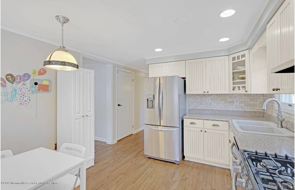 219 Jackson Pines Road Jackson, NJ 08527 - Photo 7 of 26 a kitchen with a refrigerator a sink and cabinets