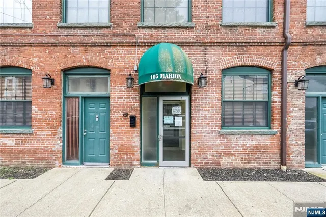 a front view of a residential apartment building with a lots of windows