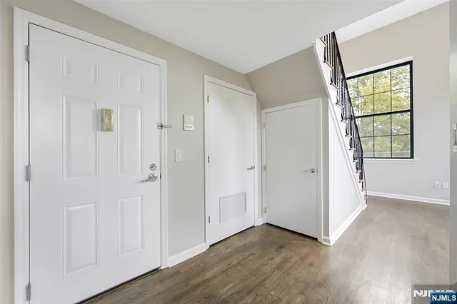 a view of room with wooden floor and windows