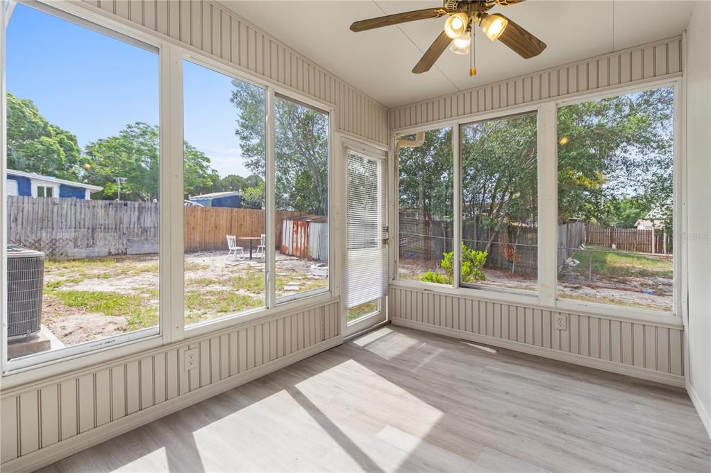7208 Fair Oaks Street Spring Hill, FL 34606 - Photo 19 of 25 a view of an empty room with wooden floor and a window