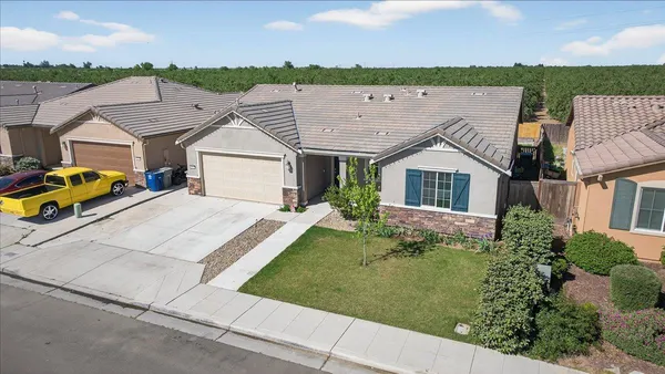an aerial view of a house with a garden and plants