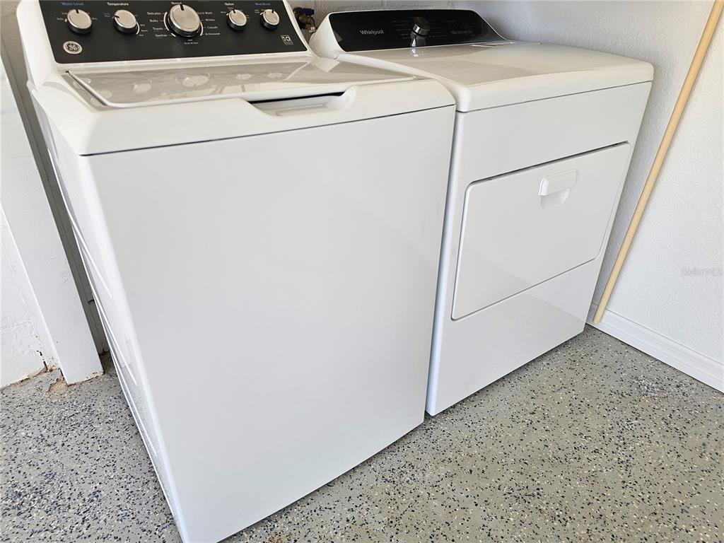 7313 Hatteras Drive Hudson, FL 34667 - Photo 25 of 33 a utility room with dryer and washer