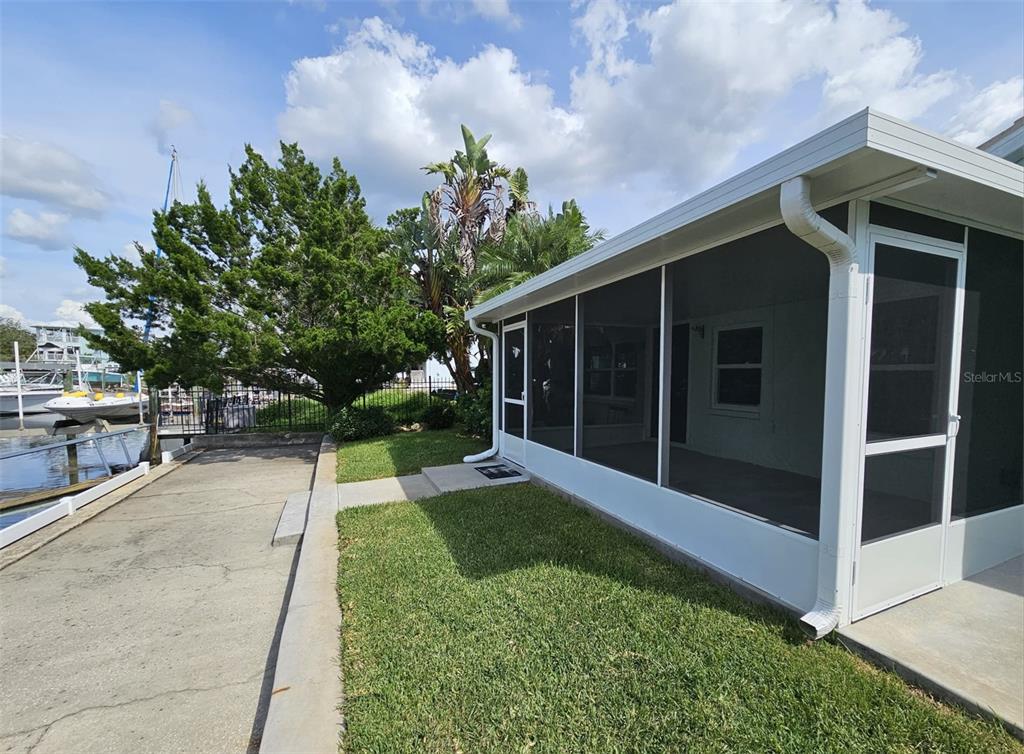 7313 Hatteras Drive Hudson, FL 34667 - Photo 29 of 33 a view of backyard with potted plants and a large tree