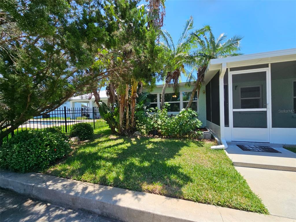 7313 Hatteras Drive Hudson, FL 34667 - Photo 33 of 33 a front view of a house with a yard