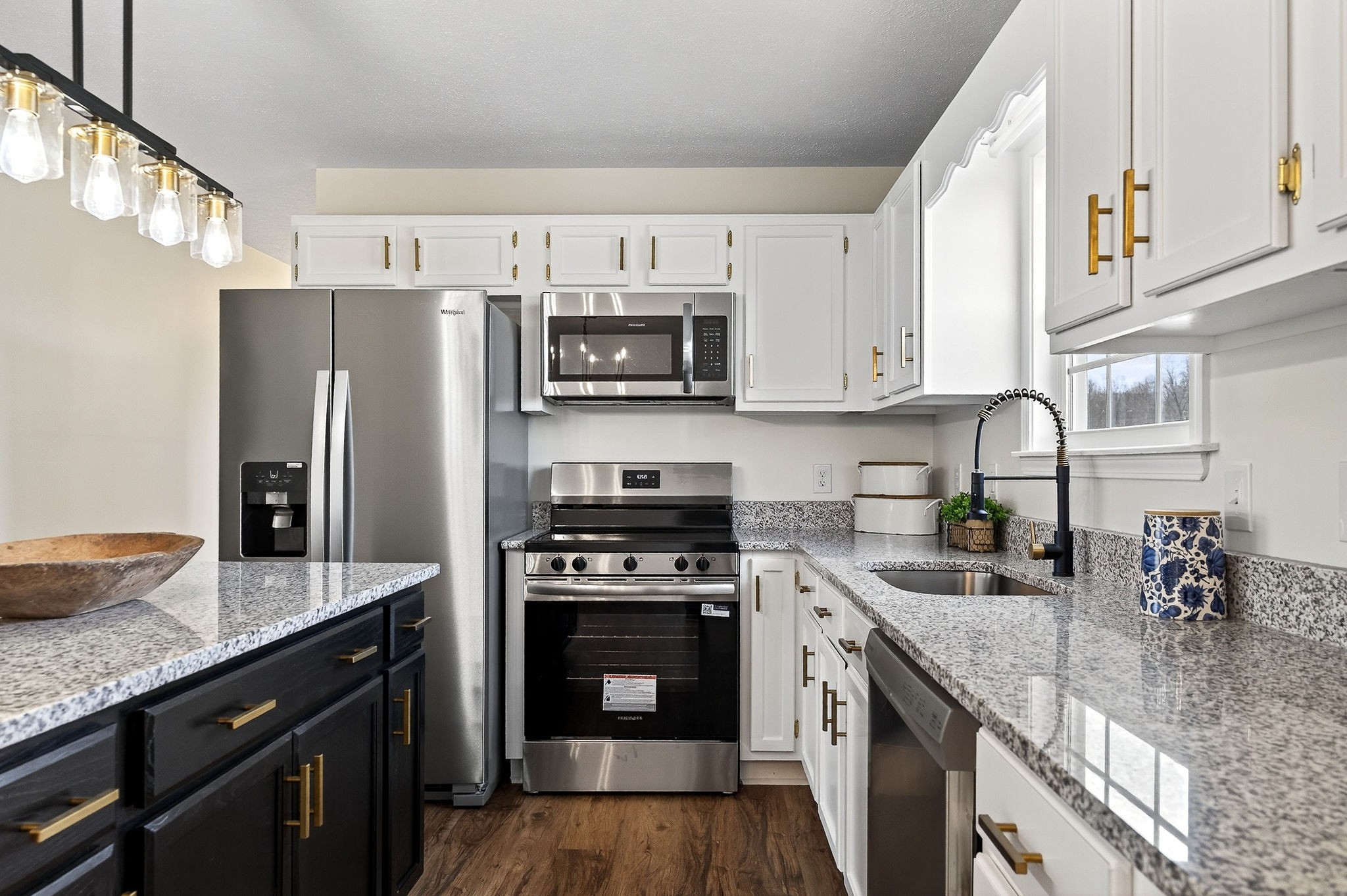 498 Low Gap Road Sparta, TN 38583 - Photo 11 of 38 a kitchen with stainless steel appliances granite countertop a stove refrigerator sink and microwave