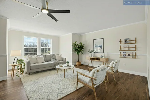 an empty room with wooden floor a ceiling fan and windows