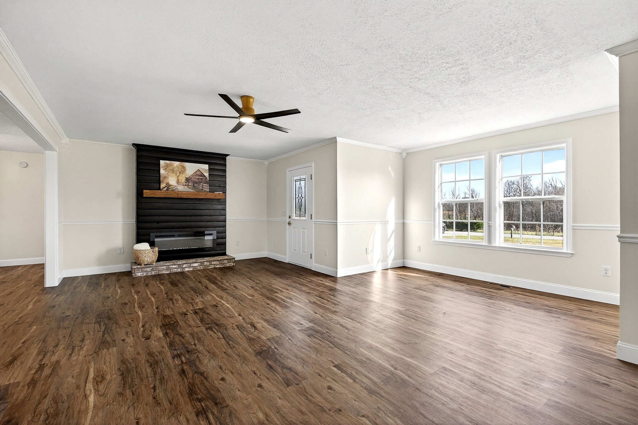 498 Low Gap Road Sparta, TN 38583 - Photo 15 of 38 an empty room with wooden floor a ceiling fan and windows