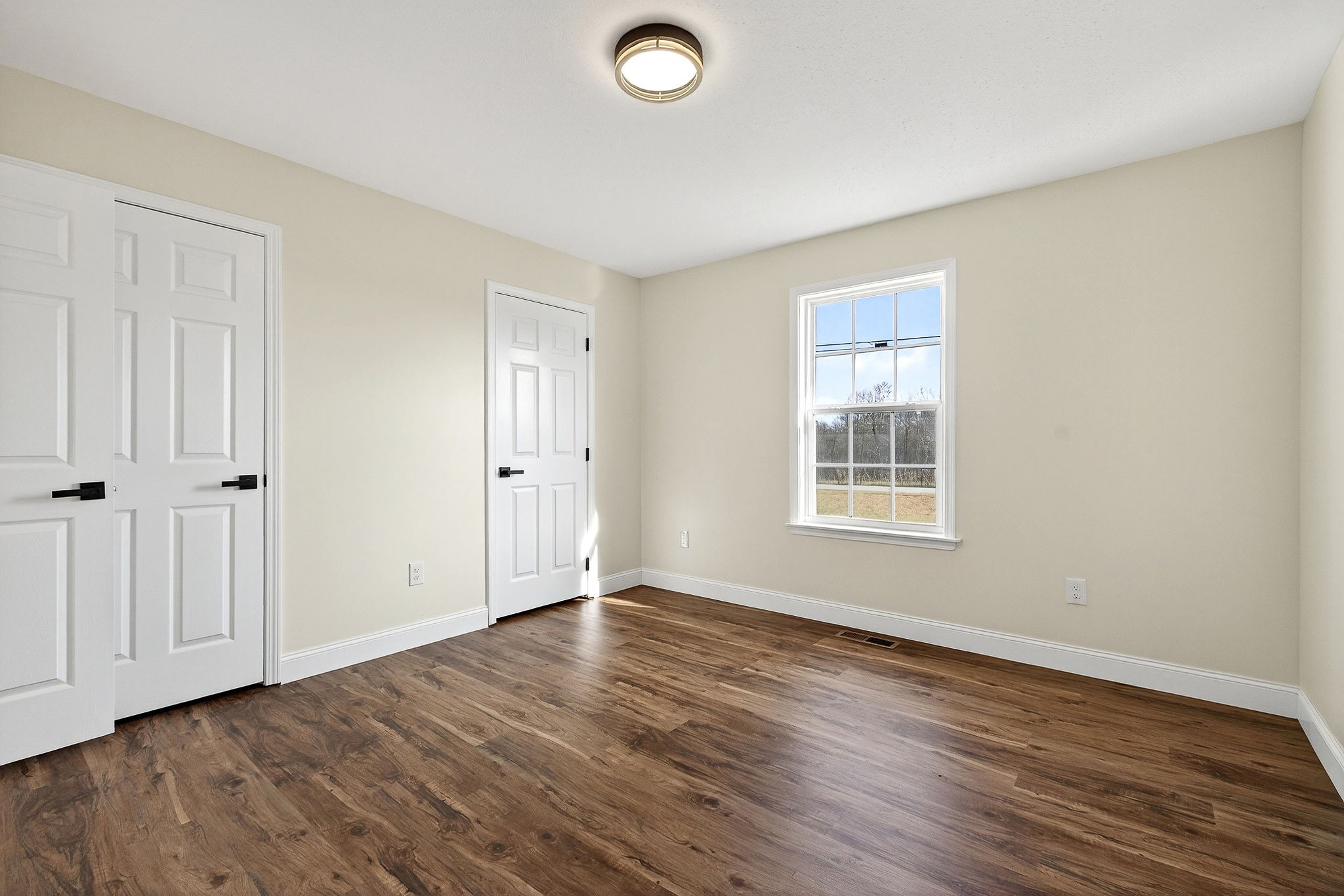 498 Low Gap Road Sparta, TN 38583 - Photo 23 of 38 a view of an empty room with wooden floor and a window