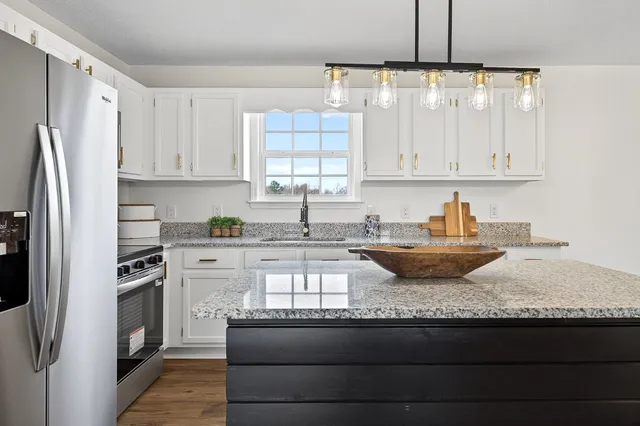 a kitchen with a sink and white cabinets