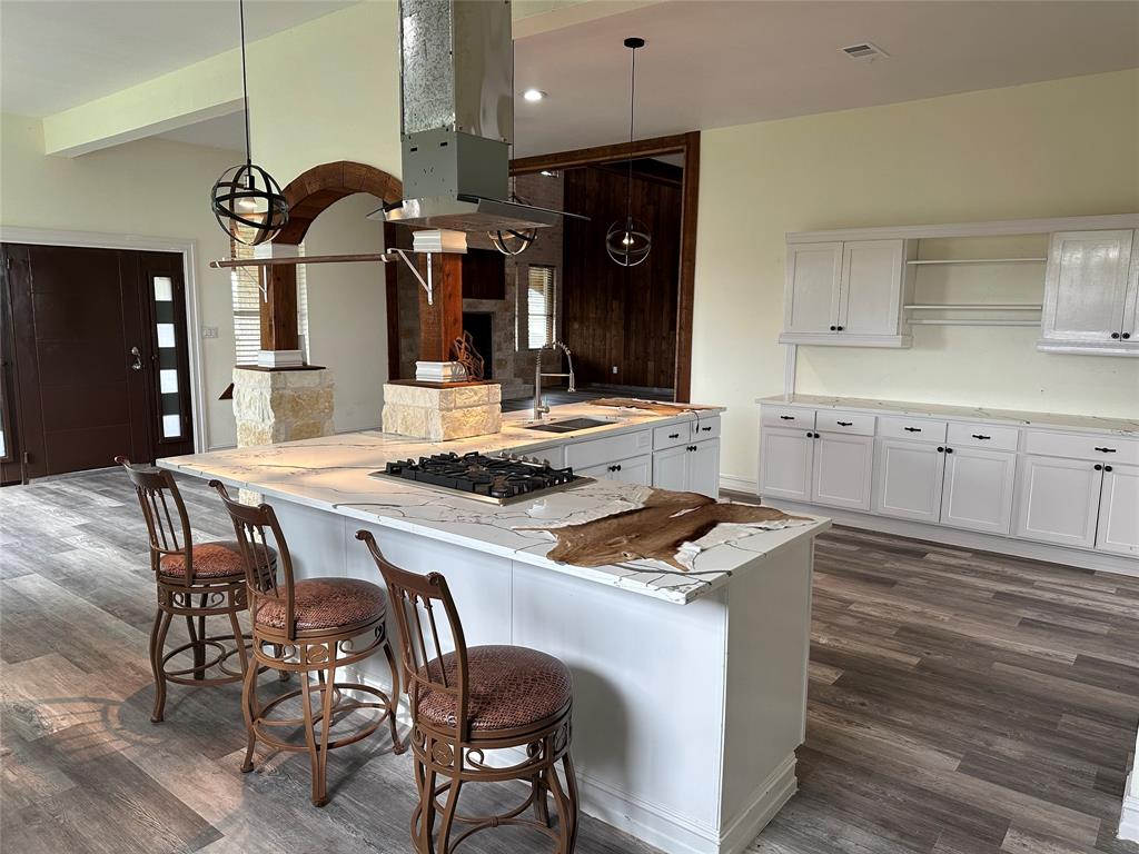 241 Gentry Road Ennis, TX 75119 - Photo 15 of 40 a kitchen with granite countertop sink table and chairs