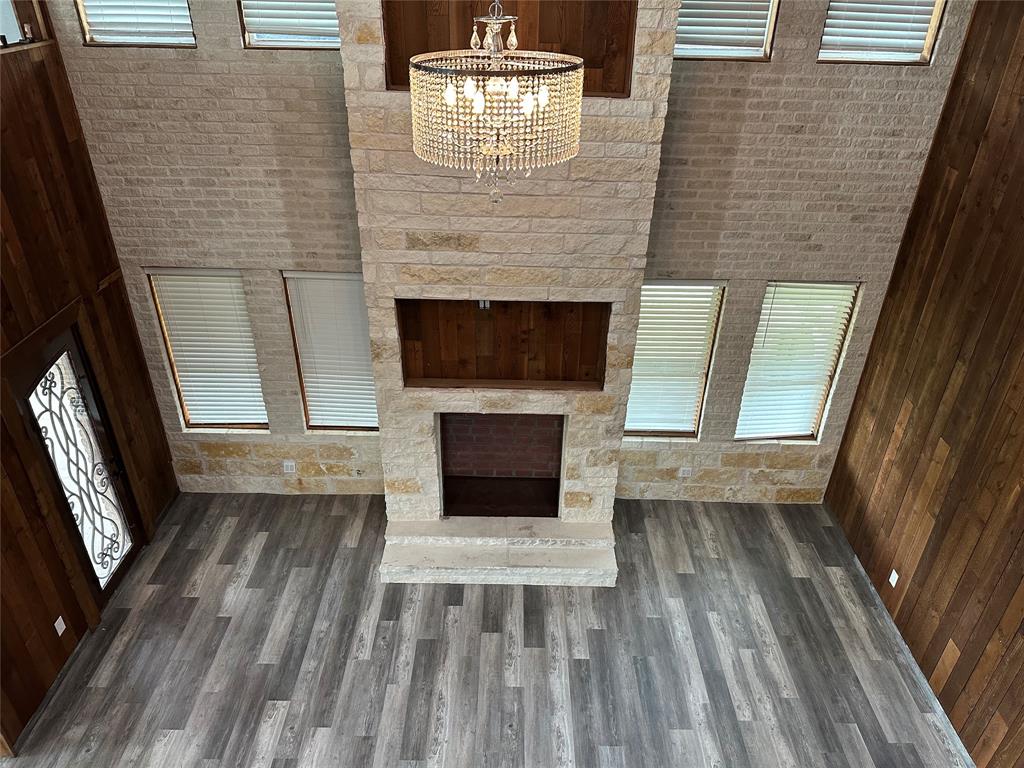 241 Gentry Road Ennis, TX 75119 - Photo 18 of 40 a view of a livingroom with wooden floor and a fireplace