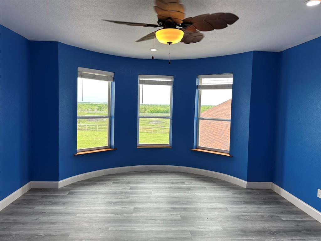 241 Gentry Road Ennis, TX 75119 - Photo 22 of 40 a view of an empty room with window and chandelier fan