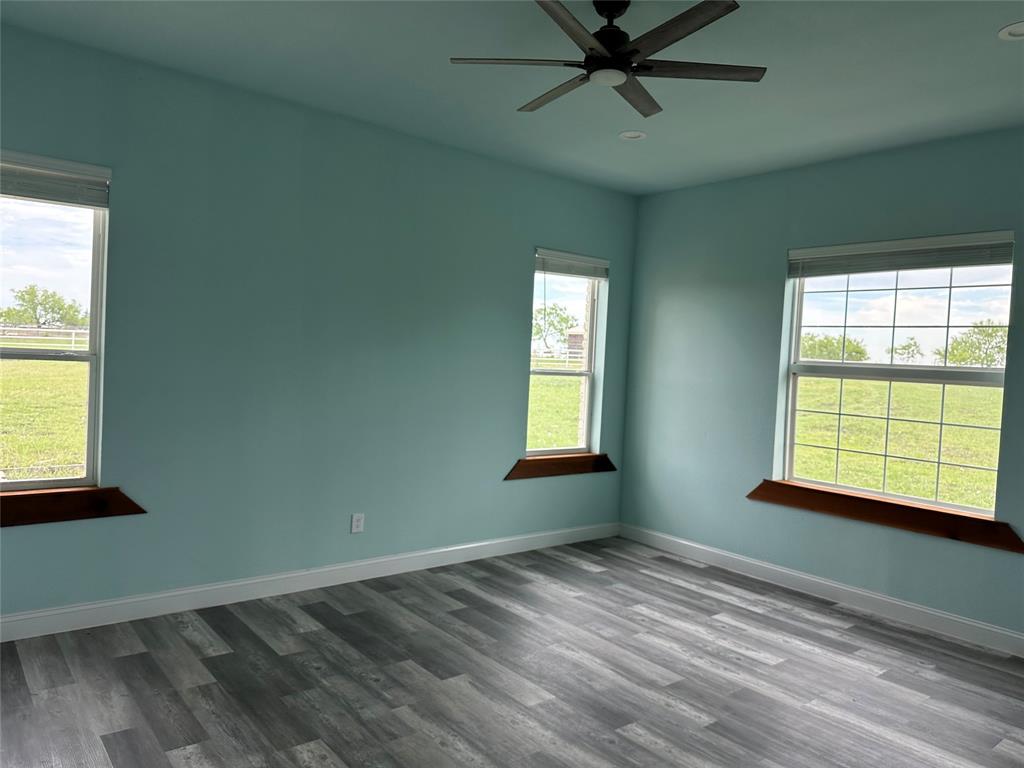 241 Gentry Road Ennis, TX 75119 - Photo 25 of 40 an empty room with a window and a fan