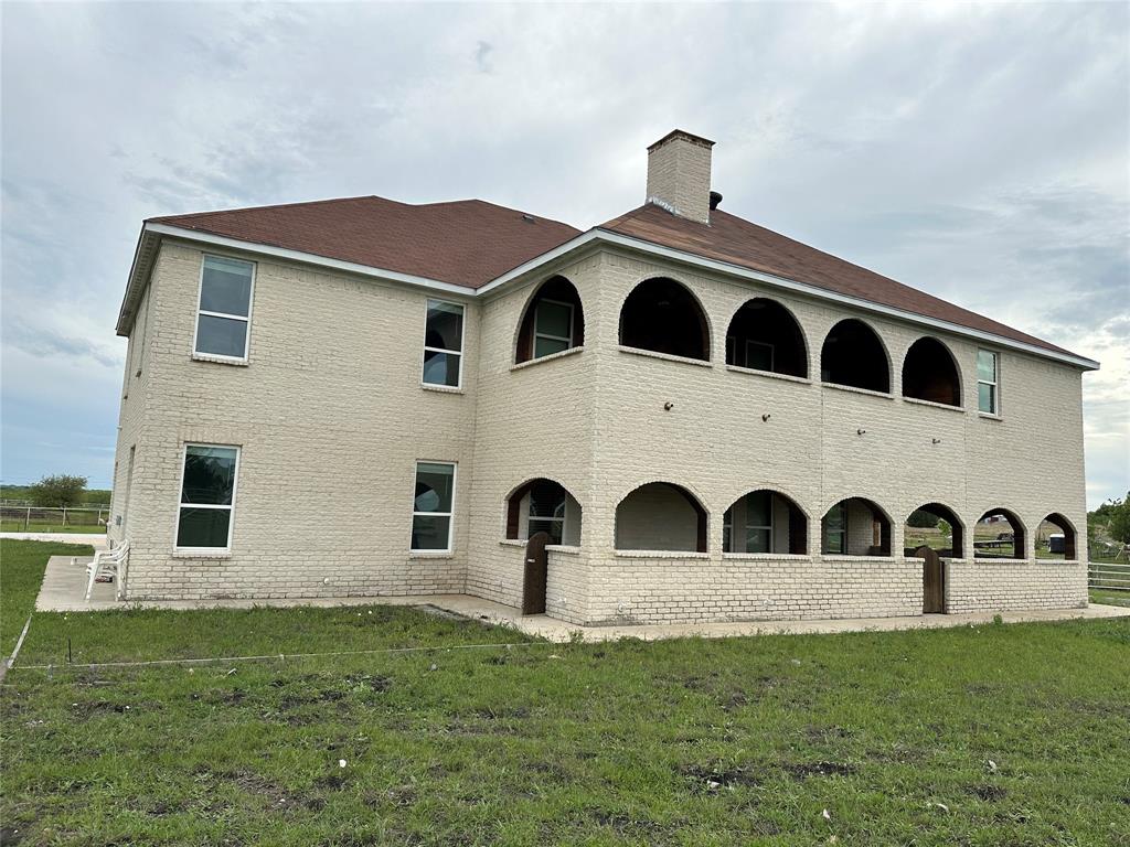 241 Gentry Road Ennis, TX 75119 - Photo 27 of 40 a front view of a house with garden