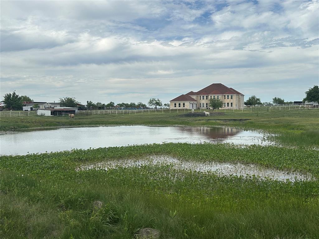 241 Gentry Road Ennis, TX 75119 - Photo 4 of 40 a view of a lake with houses in the background