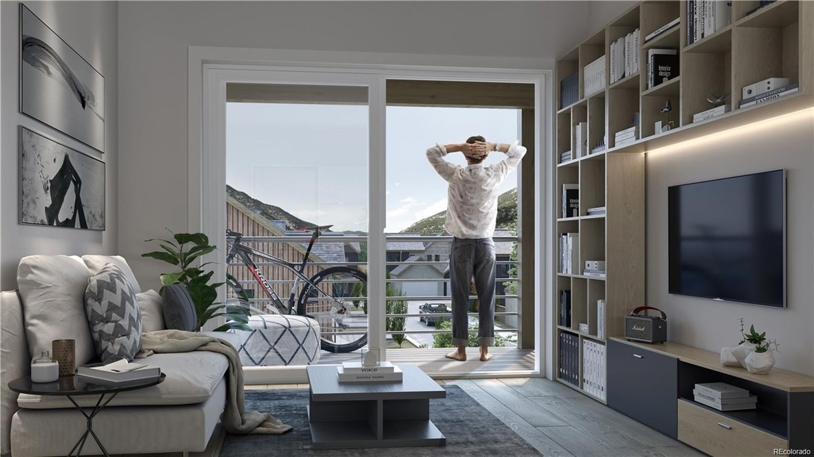 611 Bighorn Road, Unit 162 Georgetown, CO 80444 - Photo 3 of 10 a living room with furniture and a flat screen tv