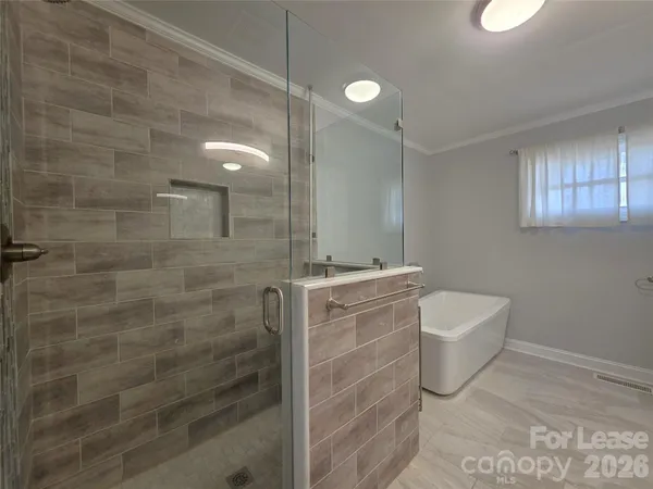 a bathroom with a granite countertop sink a toilet and shower