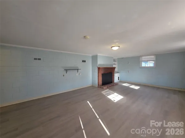 a view of empty room with a fireplace