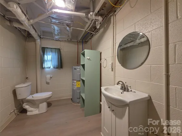 a bathroom with a sink toilet and mirror