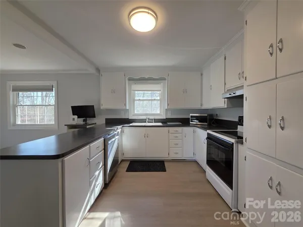 a kitchen with a sink stove and window