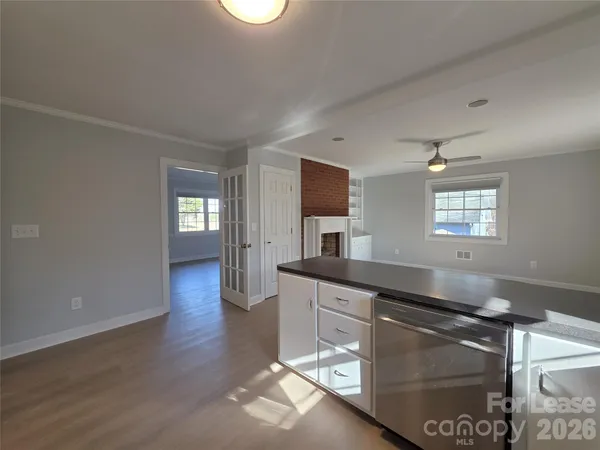 a kitchen with granite countertop a stove a sink and a microwave