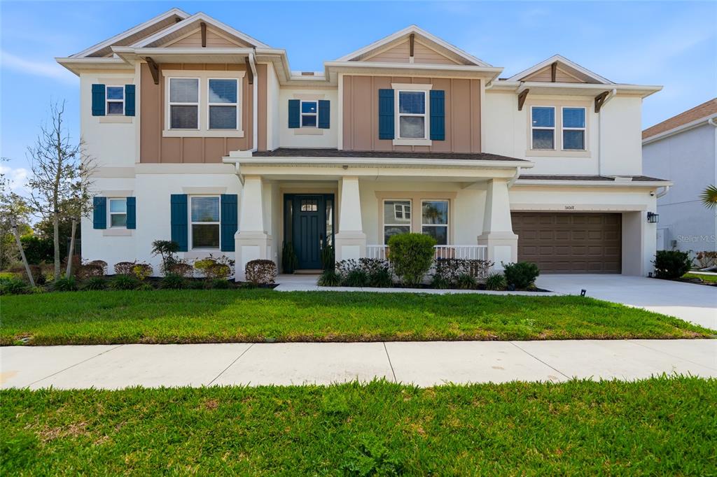 34068 Castaway Loop Wesley Chapel, FL 33543 - Photo 64 of 65 a front view of a house with a garden and yard