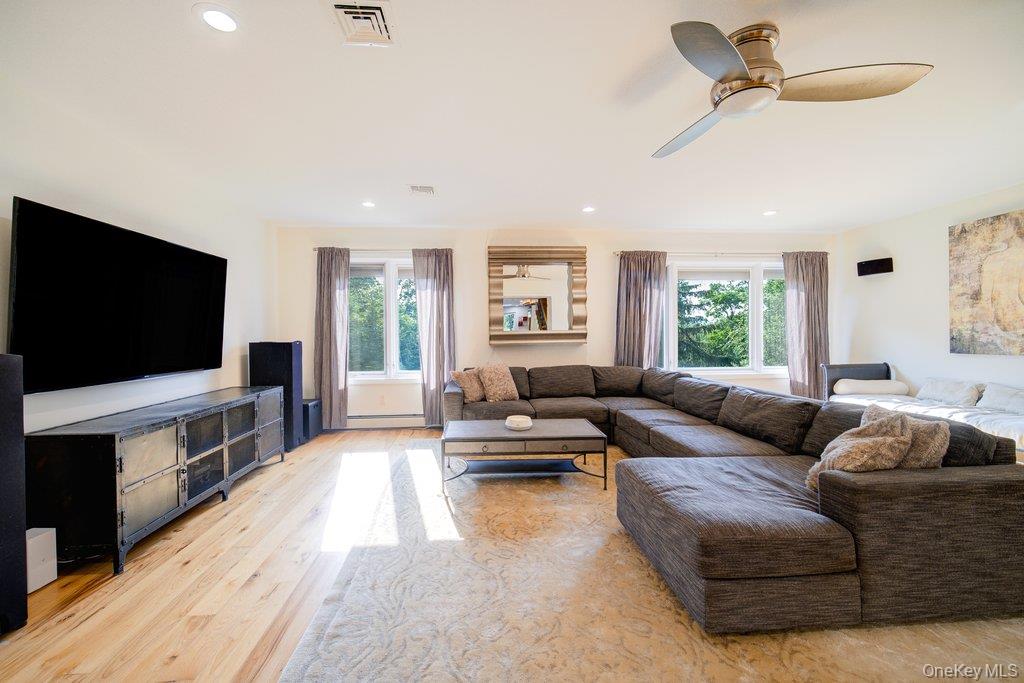 237 Mineral Springs Road Highland Mills, NY 10930 - Photo 16 of 32 Living room featuring plenty of natural light, light wood finished floors, recessed lighting, ceiling fan, and a baseboard heating unit
