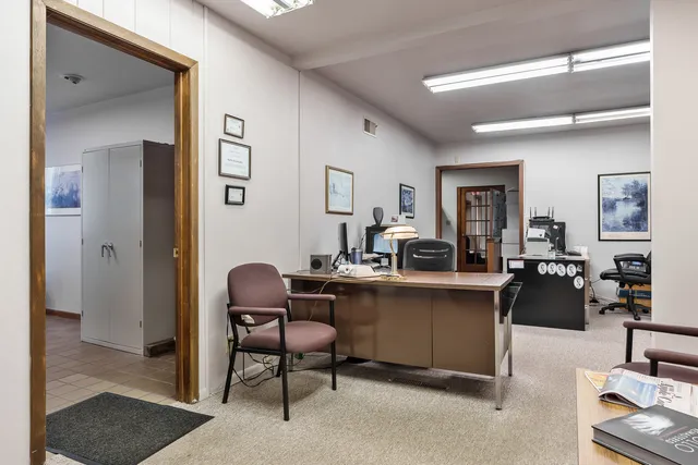 a dining hall with stainless steel appliances kitchen island granite countertop furniture and a view of kitchen