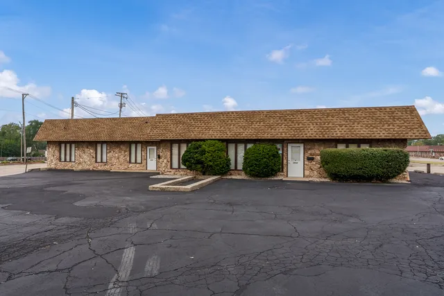 a view of a terrace with a table and chairs under an umbrella