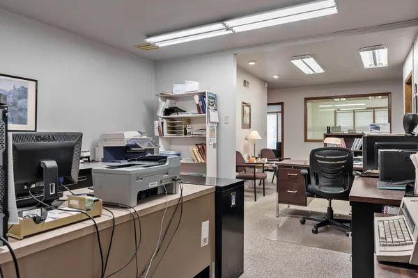 a view of a workspace with furniture and a fireplace