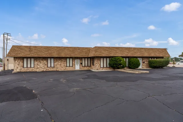 a view of a house next to a big yard