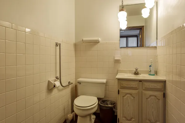 a bathroom with a sink a toilet and mirror