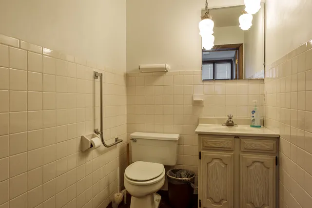a bathroom with a sink a toilet and mirror