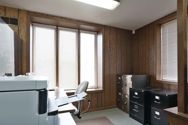 a view of workspace with windows and cabinet