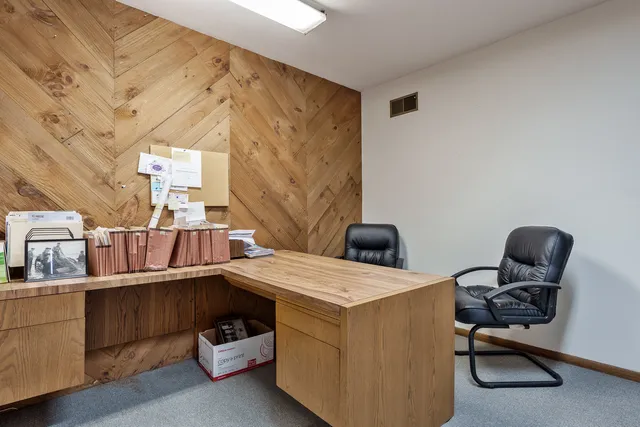 a view of a hallway with wooden staircase