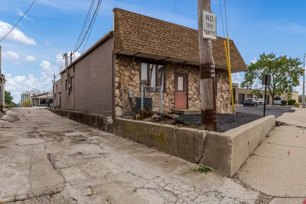 a view of a house with wooden fence